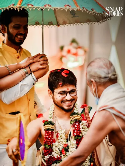 A happy groom being blessed during a pre-wedding ritual. We make sure to capture the groom's ceremonies with the same detail and care as the bride's.