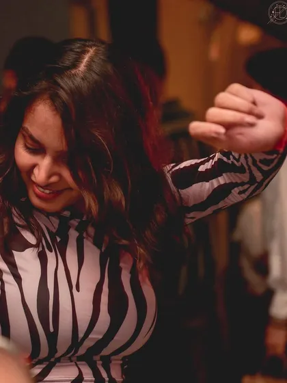 A stylish partygoer in a zebra-print top, dancing the night away.