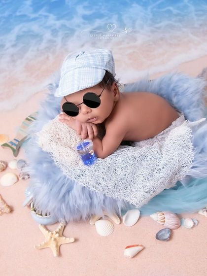 Chilling by the beach with a cool drink. This playful seaside setup, with tiny sunglasses and a cap, is perfect for capturing a fun, relaxed vibe.