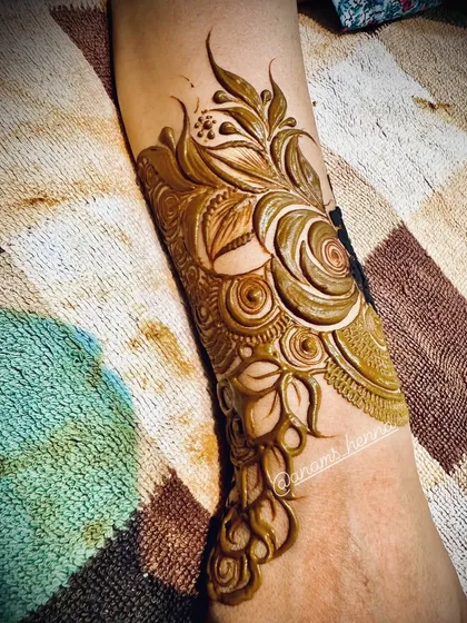 A close-up of a cuff-style design with intricate swirls and floral elements. This is a great option for a party or festival.