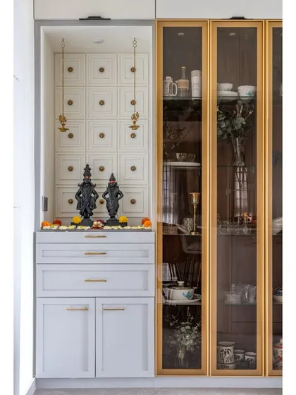 A tranquil and elegant puja unit integrated seamlessly into the home's design. We used classic paneling, soft lighting, and refined gold-toned hardware to create a dedicated space for peace and devotion that complements the surrounding decor.