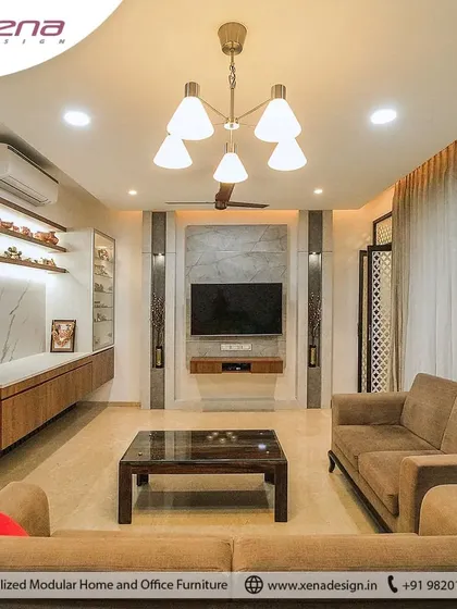 A warm and inviting living room we designed for a client. The space features a floating wooden TV console, open shelves against a backlit marble panel, and comfortable fabric sofas, creating a perfect space for family time.