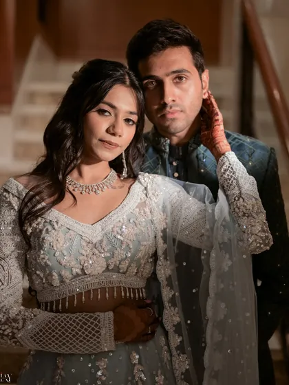 A powerful and intimate portrait of the couple. The bride's hand gently touching the groom's face creates a strong connection, and the direct eye contact with the camera is captivating.