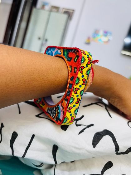 The square shape of the Banjara Bangle sits so comfortably on the wrist. Here you can see the contrast between the red and yellow patterned sides.