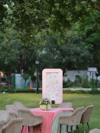 A soft-focus shot of the garden party, highlighting the beautiful ambiance created by the themed decor and natural surroundings.
