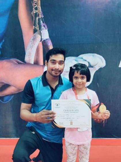 This student proudly displays her medal and certificate from a recent competition.