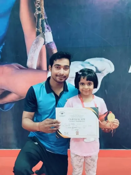 This student proudly displays her medal and certificate from a recent competition.