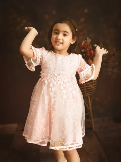 A playful moment from a third birthday shoot, with the little girl dancing and smiling.