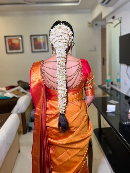 The complete bridal look is in the details. My professional hair team and I work together to create stunning traditional hairstyles, like this intricate floral braid for a South Indian bride.