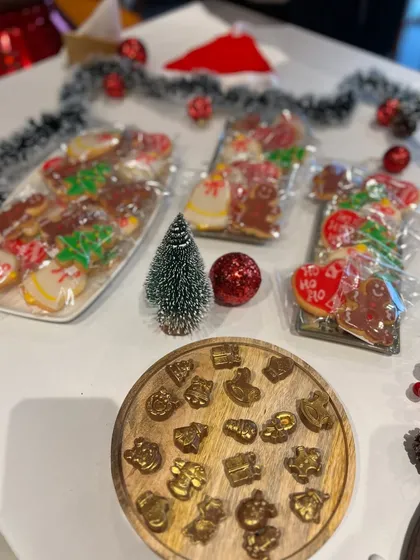 A festive display of Christmas cookies and gold-dusted chocolate bon bons for a high tea setup.