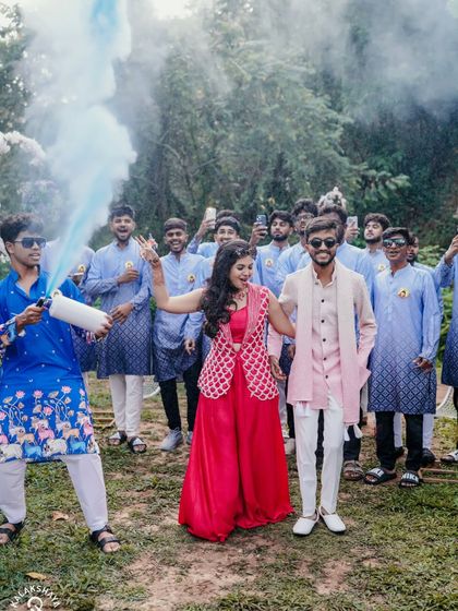 The couple's grand entrance with friends and a color smoke bomb, kicking off the Haldi party with a bang.