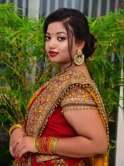 An over-the-shoulder pose that showcases the intricate beadwork on the sleeve of the blouse. We focus on capturing these important details for fashion and portfolio clients.