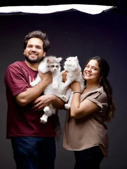 Our family isn't complete without our furry members. Here we are with our two beautiful cats, who sometimes even make a guest appearance during shoots if clients are comfortable.