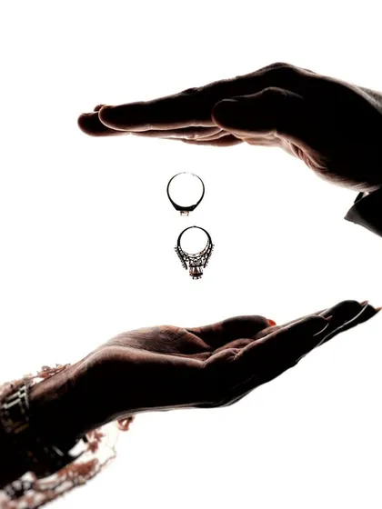 A creative and symbolic portrait of commitment. This high-contrast silhouette shot focuses on the rings, representing the promise and the bond you share, captured in an artistic and minimalist style.