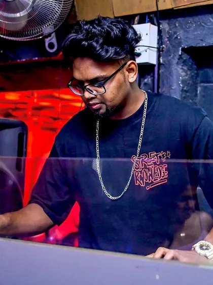 Focused on the mix at The Gypsy Pub. I blend different genres seamlessly, from hip-hop to pop, ensuring the music flows perfectly throughout the night.