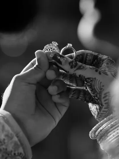 A classic black and white shot of the engagement rings. This timeless style highlights the symbolism and importance of the moment.