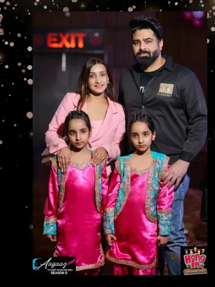 A beautiful family portrait at Aagaaz. These twin performers, dressed in matching Bhangra outfits, pose with their parents.