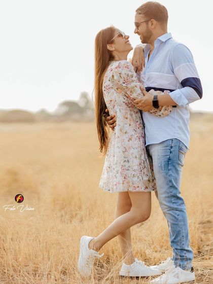 A romantic portrait of the couple in a golden field at sunset, a classic and timeless pre-wedding shot.