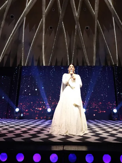 A full view of the stage and me during a Sangeet. I am experienced in hosting on grand stages, making sure every guest feels like part of the celebration.