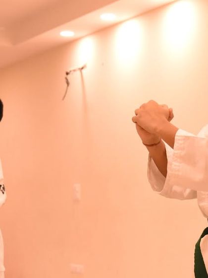 Two students execute a pattern in unison, their focus unwavering during the exam.