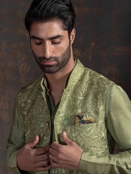 Refine your elegance with this sophisticated green Nehru jacket and kurta set. The rich color and subtle embroidery are crafted to bring out your timeless charm and embrace the allure of tradition.