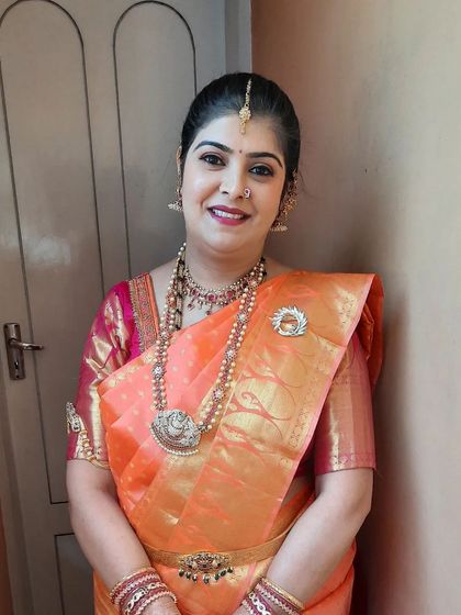 Another portrait shot, capturing her smile and the elegance of the final look.