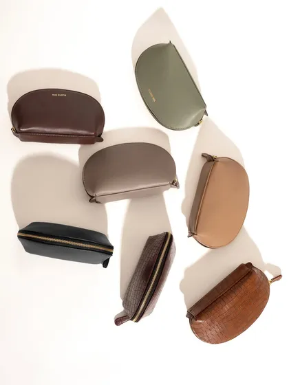 A creative flat-lay of multiple half-moon pouches in various colors. The play with light and shadow adds depth and artistry to what could be a simple product lineup, making it more engaging.
