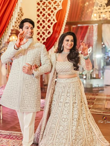 Divya and Rahul make their grand entrance, waving to their guests. We capture the excitement and happiness of the couple as they begin their celebration.
