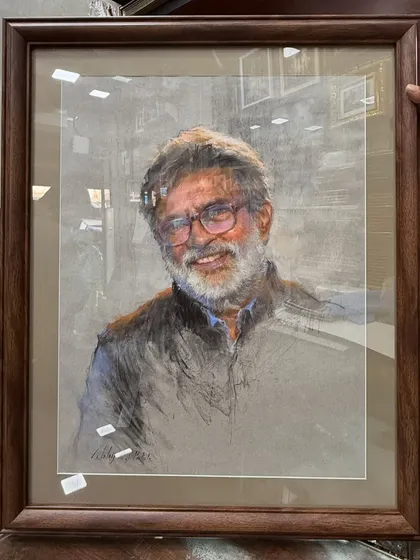 The framed soft pastel portrait of Mr. Vasudeo Kamath, ready for presentation.