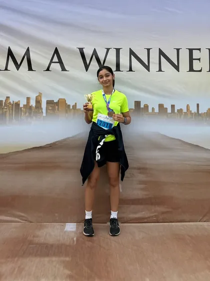 "I am a winner." Aayra Dalvi stands proudly with her trophy and medal after a podium finish at the Bawa Juniorthon.
