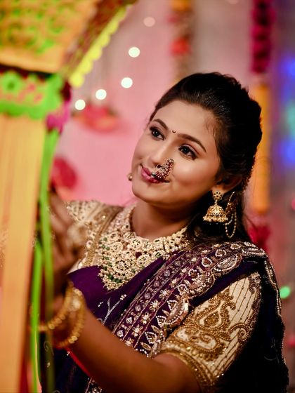 A candid moment of decorating the home for Diwali, dressed in a beautiful traditional outfit.