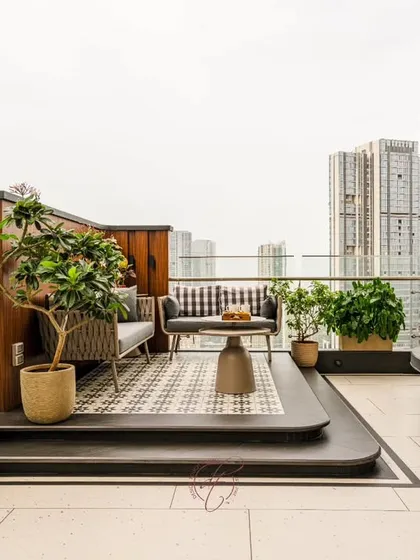 The elevated lounge area on the terrace offers a comfortable and stylish spot to relax and take in the city views. The patterned rug and modern furniture create a boutique-cafe feel.