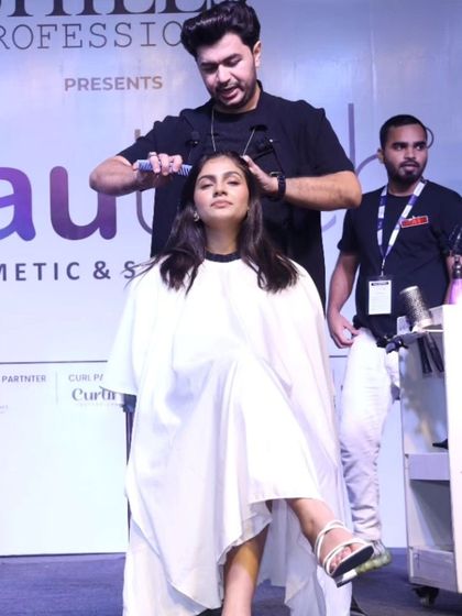 Applying product and perfecting a style on stage at the Beautech Expo. Every detail counts when you're creating a look for the runway.