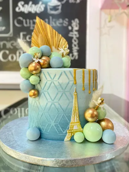 A close-up view of the intricate details on the Paris-themed cake.