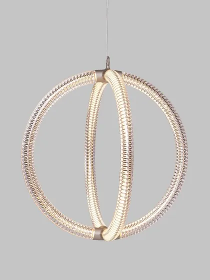 A studio shot of the Luminora pendant, highlighting the intricate, V-shaped diamond pattern on its surface. This detail shows the complexity and elegance that is achieved through its seemingly simple circular form.