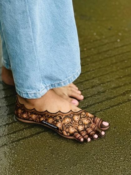 A clear, still shot of our intricate foot mehandi design. The pattern is dense and symmetrical, creating a beautiful adornment that resembles a traditional payal.