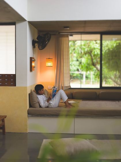A view of the built-in daybed, a perfect spot for an afternoon read. The space is designed to be a sanctuary, with soft lighting, natural textures, and a direct connection to the tranquil garden outside.