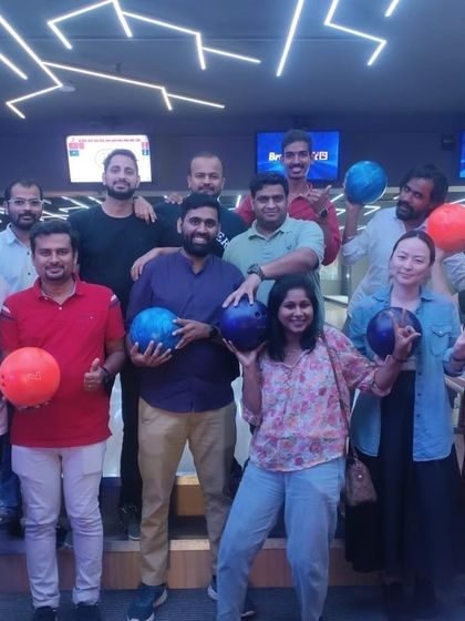 A corporate team having fun with bowling balls.