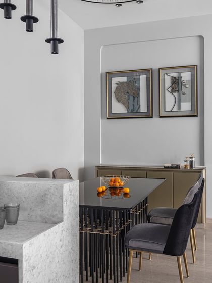 A closer look at the dining space, where curated art pieces on the wall add a layer of personality. The design focuses on creating an elegant atmosphere for family meals and entertaining guests.