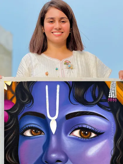Me holding the finished painting of Krishna's eyes, a piece that reflects both art and devotion.