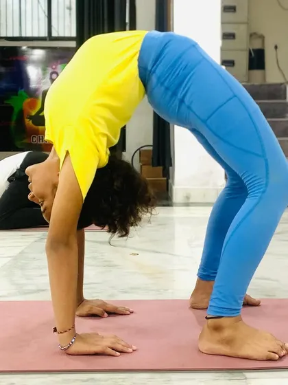 The Urdhva Dhanurasana (Wheel Pose) is an energizing backbend that opens the chest and strengthens the entire body. This student shows great form and spinal flexibility.