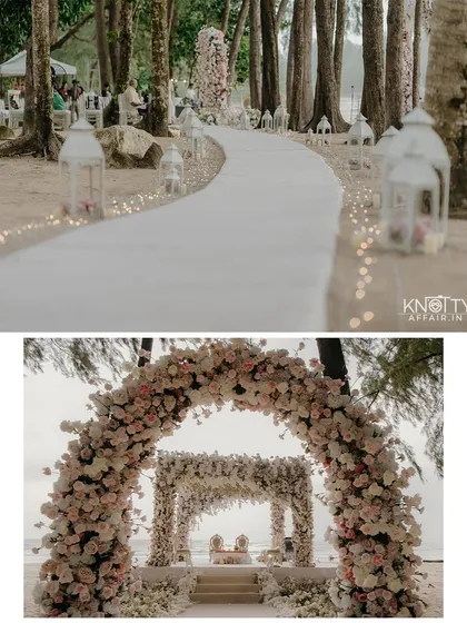 The stunning decor of the Thailand beach ceremony. The floral archway and lantern-lined aisle create a magical path leading to the mandap, perfectly blending elegance with the natural tropical setting.