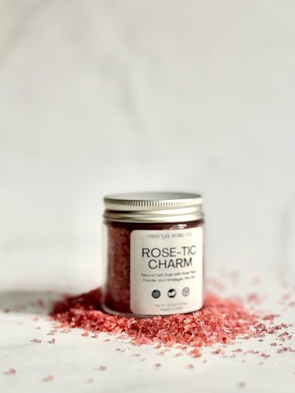 Our Rose-Tic Charm salt soak, beautifully packaged in a glass jar with a metal lid. It's the perfect addition to your self-care ritual.