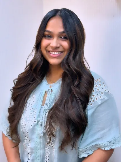 A perfect hair day look. This client's smile and her beautiful, wavy balayage are a winning combination.
