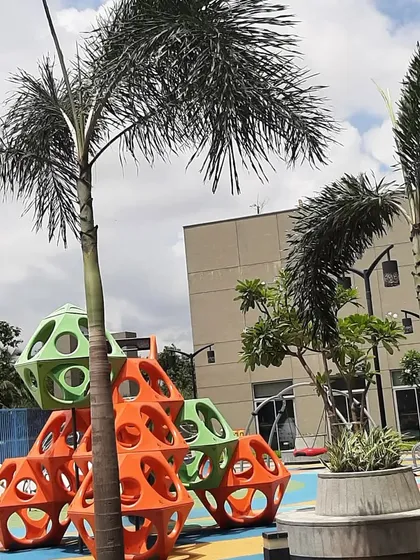 We use sculptural and modular play equipment to create visually interesting and challenging play areas. The geometric climbing structure, set amongst palm trees, adds an artistic element to the playground at the Island City Center.
