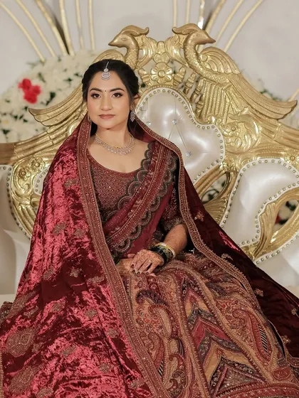 For this bride's grand reception, we went for a regal and glamorous look. I styled her in a stunning velvet lehenga, creating a makeup look with a bolder lip and defined eyes that complemented the richness of her outfit and the evening's celebrations.