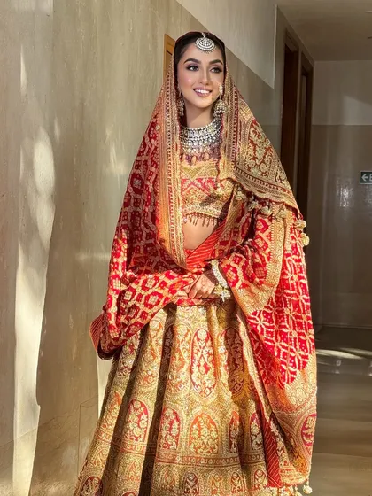 The sunlight catching the intricate work on this Rimple & Harpreet creation is just magical. My styling for this look was about letting the bride's natural joy and the outfit's craftsmanship shine through.