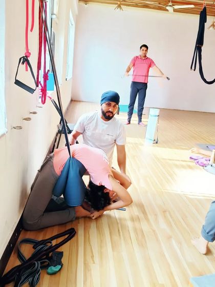 A deep, restorative pose using the wall ropes and a chair. This is excellent for releasing tension in the entire back body.