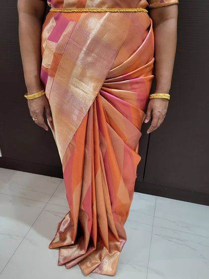 A close-up of the hip pleats and center pleats. This combination creates a flattering shape and adds a touch of modern flair to the drape.