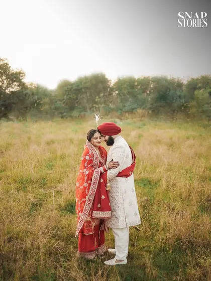 A romantic outdoor portrait of the couple in their wedding attire. The natural setting provides a beautiful, soft backdrop for this intimate moment.